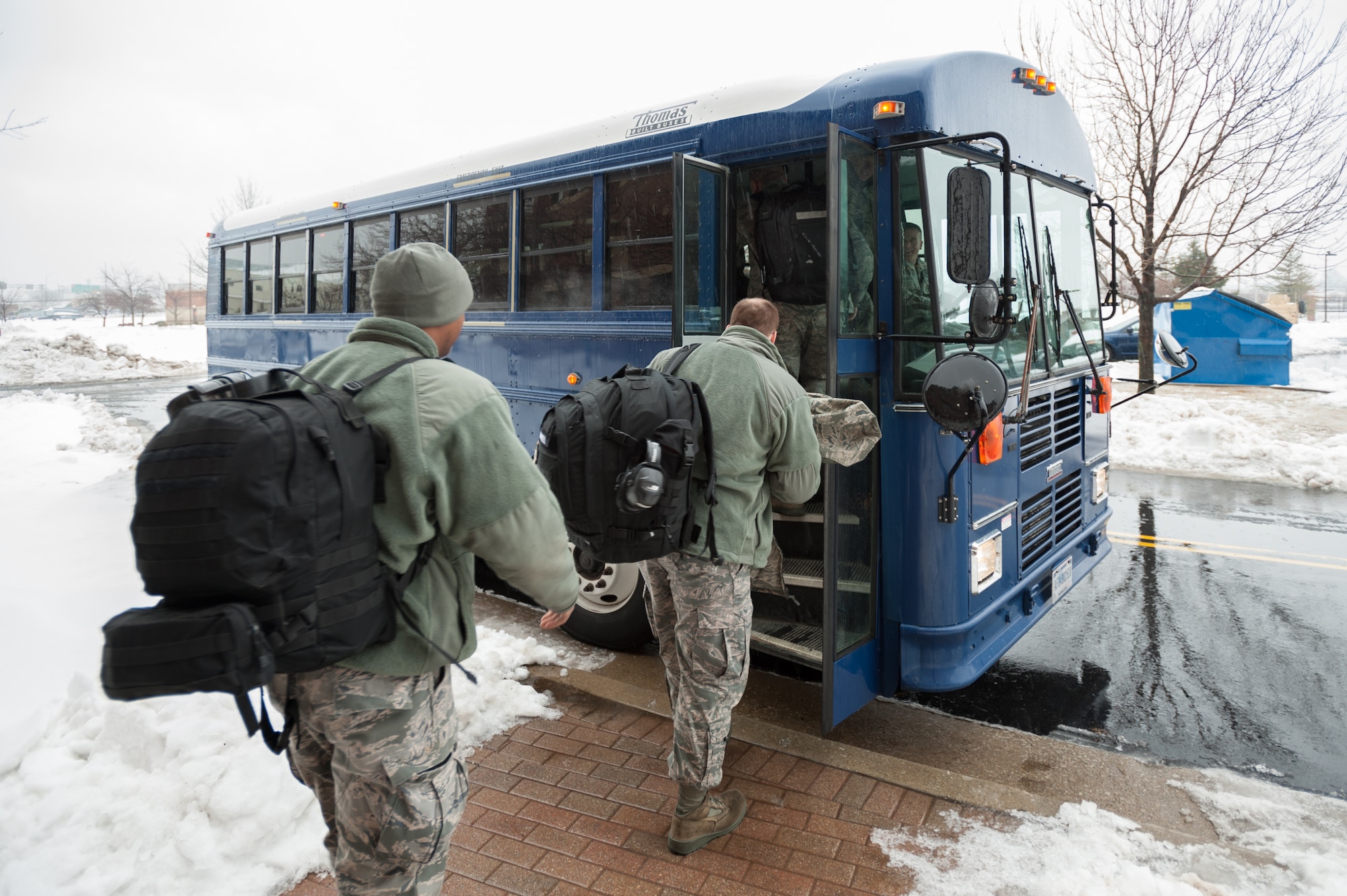 Members of the 123rd Airlift Wing board a bus that will take them to their C-130 Hercules aircraft at the Kentucky Air National Guard Base in Louisville, Ky., Feb. 21, 2015. The Airmen are heading to the Persian Gulf for a four-month deployment in support of Operation Freedom's Sentinel. (U.S. Air National Guard photo by Maj. Dale Greer)