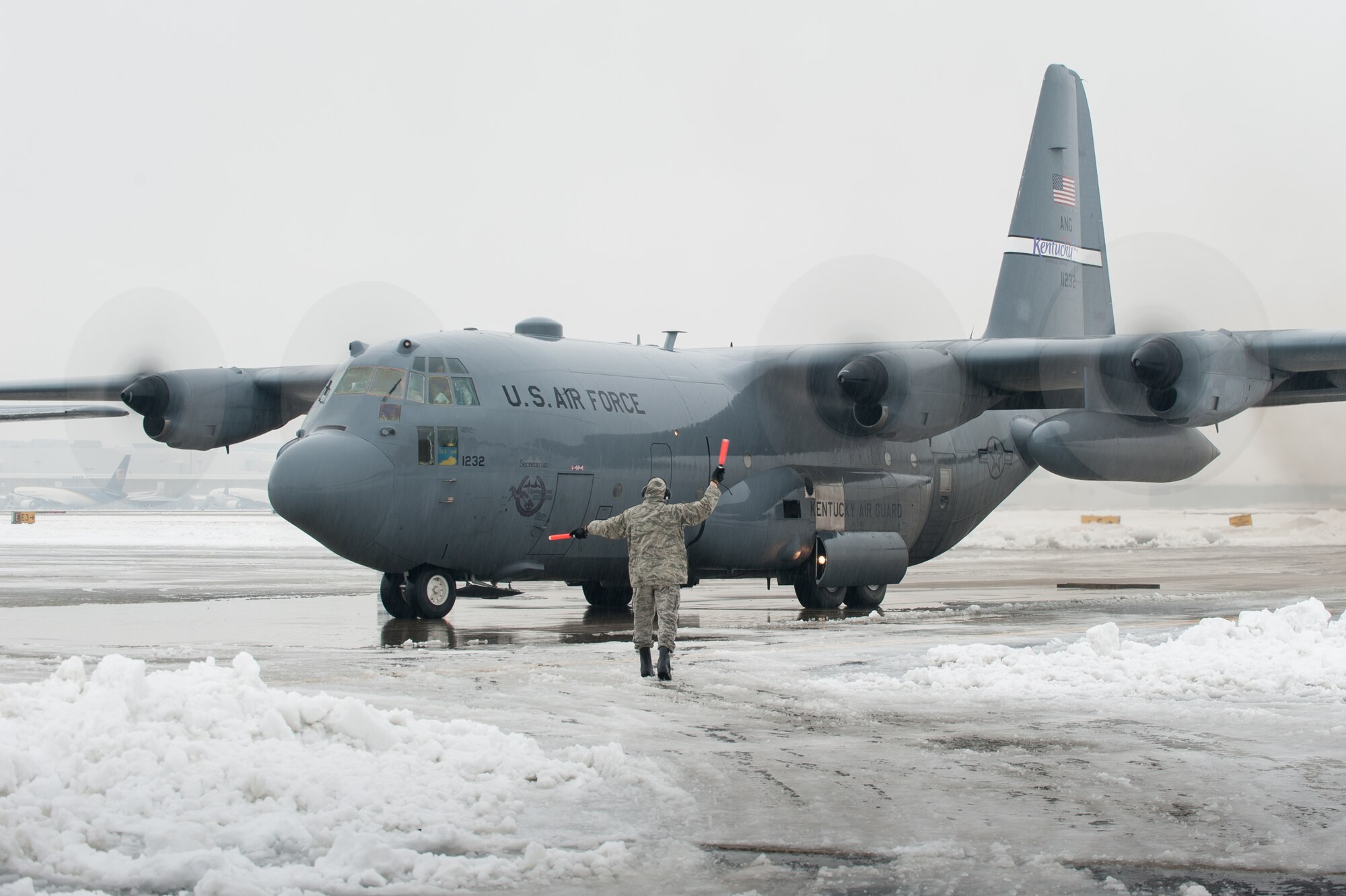 More than 35 members of the 123rd Airlift Wing depart the Kentucky Air National Guard Base in Louisville, Ky., Feb. 21, 2015, aboard a C-130 Hercules aircraft for a four-month deployment to the Persian Gulf region in support of Operation Freedom's Sentinel. The Airmen will fly troops and cargo across the U.S. Central Command Area of Responsibility, which includes the Persian Gulf, Northern Africa and Afghanistan. (U.S. Air National Guard photo by Maj. Dale Greer)