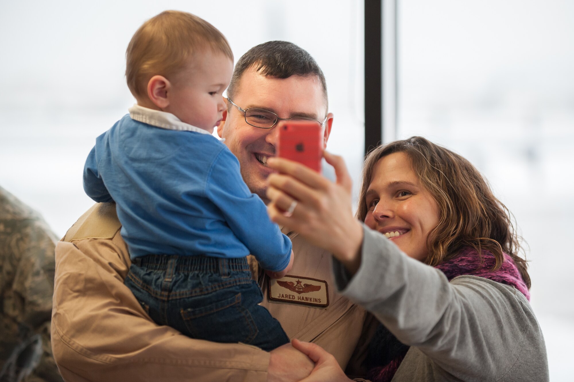 Maj. Jared Hawkins, a C-130 Hercules navigator in the 123rd Airlift Wing, poses for a selfie with his son and wife, Jaime and Lairkin Hawkins, at the Kentucky Air National Guard Base in Louisville, Ky., Feb. 21, 2015. Hawkins is deploying to the Persian Gulf in support of Operation Freedom's Sentinel, during which more than 110 members of the Kentucky Air Guard will fly troops and cargo across the U.S. Central Command Area of Responsibility. (U.S. Air National Guard photo by Maj. Dale Greer)