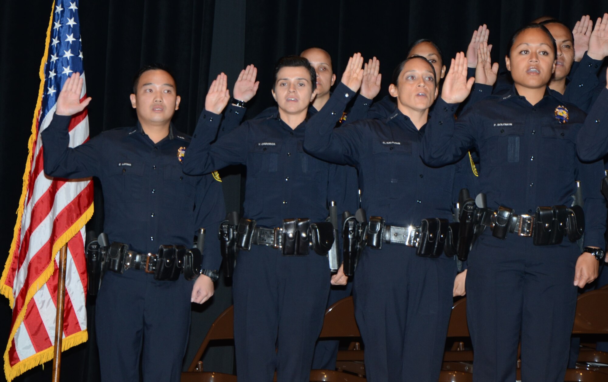 Tech. Sgt. Celsa Salazar, third from left front row, a personnelist with the 624th Regional Support Group, Joint Base Pearl Harbor-Hickam, Hawaii, takes the oath to uphold the law with her fellow HPD officers from recruit class #178, during a commencement ceremony at McKinley High School auditorium, Honolulu, Feb. 11. (U.S. Air Force photo by Tech. Sgt. Phyllis Keith)


