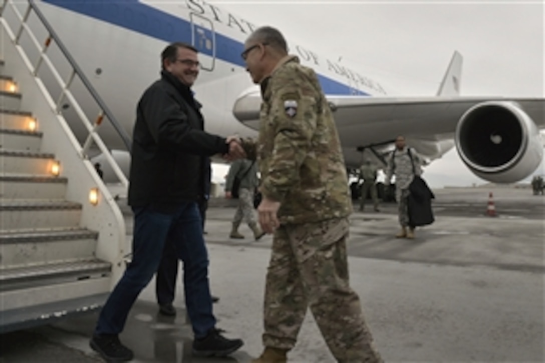 U.S. Army Gen. John F. Campbell, commander of U.S. forces in Afghanistan and Operation Resolute Support, greets U.S. Defense Secretary Ash Carter as he arrives in Kabul, Afghanistan, Feb. 21, 2015. During his first overseas trip as secretary, Carter plans to meet with Afghan leaders and U.S. service members.