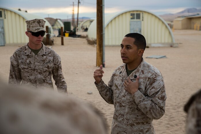 Staff Sgt. Absalon A. Cabrera (Right) debriefs his Marines after training Jan. 21 at Marine Air Ground Combat Center Twentynine Palms, California, during Integrated Training Exercise 2-15. “To bring a different group of Marines together and have them do the same thing an infantry unit would do is great,” said Cabrera. “The Marines have met that standard here.” Cabrera, an infantry unit leader, and Los Angeles, California, native, is the convoy commander for the 4th Marine Regiment jump team. ITX 2-15 is designed to integrate combined arms and improve warfighting capabilities. Cabrera is with Headquarters Company, 4th Marines, 3rd Marine Division, III Marine Expeditionary Force. 