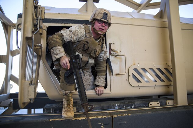 Lance Cpl. Joseph A. Daniel exits the mine resistant ambush protected vehicle egress simulator Jan. 22 at Marine Air Ground Combat Center Twentynine Palms, California, during Integrated Training Exercise 2-15. The MRAP egress simulator acts as an overturning vehicle and trains the Marines on how to safely exit the vehicle and simultaneously provide 360 degree security. ITX 2-15 is designed to integrate combined arms and improve warfighting capabilities. Daniel, a radio operator and Danielsville, Georgia, native, is assigned to Headquarters Company, 4th Marine Regiment, 3rd Marine Division, III Marine Expeditionary Force. 