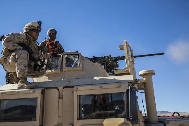 Staff Sgt. Absalon A. Cabrera guides his gunner on target at a range at Marine Air Ground Combat Center Twentynine Palms, California, Jan. 26 during Integrated Training Exercise 2-15. The jump team trained with machine guns, and fire and maneuver to hone their convoy skills to be able to successfully move the command element’s commanding officer. ITX 2-15 is designed to integrate combined arms and improve warfighting capabilities. Cabrera, an infantry unit leader, is the jump team commander with Headquarters Company, 4th Marine Regiment, 3rd Marine Division, III Marine Expeditionary Force. 