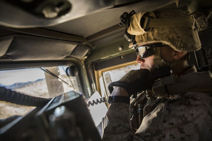 Lance Cpl. Bradley W. Walsh communicates with the rest of his convoy over the radio to maintain standard operating procedures Feb. 12 at Marine Air Ground Combat Center Twentynine Palms, California, during Integrated Training Exercise 2-15. During the battalion assault courses the jump team moved the command element’s commanding officer to a landing zone to be picked up by a UH-1Y Venom helicopter. The commanding officer was then able to command the fight from the sky. ITX 2-15 is designed to integrate combined arms and improve warfighting capabilities. Walsh, an rifleman, and Granville, Ohio, native, is the assistant convoy commander for the jump team with Headquarters Company, 4th Marine Regiment, 3rd Marine Division, III Marine Expeditionary Force. 