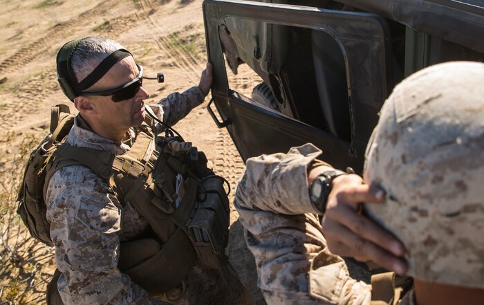 Col. David L. Odom (left) prepares his equipment before boarding a UH-1Y Venom helicopter to command the fight from the sky during the battalion assault course Feb. 12 at Marine Air Ground Combat Center Twentynine Palms, California, as part of Integrated Training Exercise 2-15. The battalion assault course incorporates all elements of Special Purpose Marine Air-Ground Task Force Four to test all capabilities. Odom, a Hartsville, South Carolina, native, is the commanding officer for 4th Marine Regiment, 3rd Marine Division, III Marine Expeditionary Force and Special Purpose Marine Air-Ground Task Force Four for ITX 2-15. 