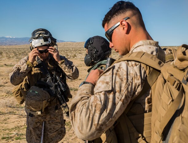 David L. Odom (left) and Cpl. Christopher J. Benavidez adjust their gear before boarding a UH-1Y Venom helicopter to command the battalion assault course from the air Feb. 12 at Marine Air Ground Combat Center Twentynine Palms, California, during Integrated Training Exercise 2-15. Odom commands the fight from the sky to get a better aerial view of the ground units to direct them to effectively to different objectives. Benavidez flys with Odom to allow him to communicate with the supporting units during the battle. ITX 2-15 is designed to integrate combined arms and improve warfighting capabilities. Benavidez, a Livermore, California, native, is a radio operator currently assigned to Headquarters Company, 4th Marine Regiment, 3rd Marine Division, III Marine Expeditionary Force. Odom, a Hartsville, South Carolina, native, is the commanding officer for 4th Marines and Special Purpose Marine-Air Ground Task Force Four for ITX 2-15. 