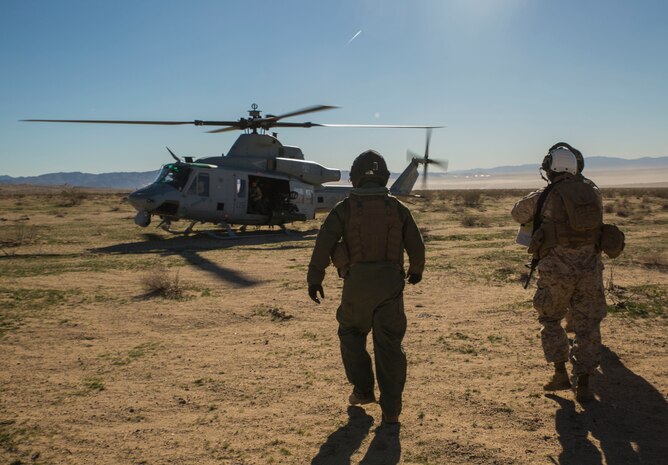 Col. David L. Odom boards a UH-1Y Venom helicopter Feb. 12 at Marine Air Ground Combat Center Twentynine Palms, California, to command the fight from the sky during Integrated Training Exercise 2-15. Cpl. Christopher J. Benavidez flies with Odom to keep active communication with the combat operation center and the ground units during the battle. ITX 2-15 is designed to integrate combined arms and improve warfighting capabilities. Benavidez, a Livermore, California native, is a radio operator with Headquarters Company, 4th Marine Regiment, 3rd Marine Division, III Marine Expeditionary Force. Odom, a Hartsville, South Carolina, native, is the commanding officer for 4th Marines and Special Purpose Marine Air-Ground Task Force Four for ITX 2-15. 