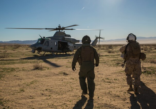 Col. David L. Odom boards a UH-1Y Venom helicopter Feb. 12 at Marine Air Ground Combat Center Twentynine Palms, California, to command the fight from the sky during Integrated Training Exercise 2-15. Cpl. Christopher J. Benavidez flies with Odom to keep active communication with the combat operation center and the ground units during the battle. ITX 2-15 is designed to integrate combined arms and improve warfighting capabilities. Benavidez, a Livermore, California native, is a radio operator with Headquarters Company, 4th Marine Regiment, 3rd Marine Division, III Marine Expeditionary Force. Odom, a Hartsville, South Carolina, native, is the commanding officer for 4th Marines and Special Purpose Marine Air-Ground Task Force Four for ITX 2-15. 