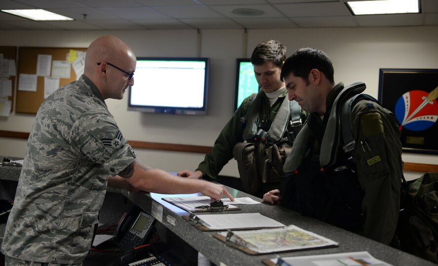Senior Airman Adam Martin, a 51st Operations Support Squadron weather flight forecaster, gives a weather brief to 25th Fighter Squadron pilots prior to flying a training sortie Feb. 12, 2015, at Osan Air Base, Republic of Korea. The flight is the focal point for all weather services to the 51 FW and other units assigned to Osan. (U.S. Air Force photo by Senior Airman David Owsianka)