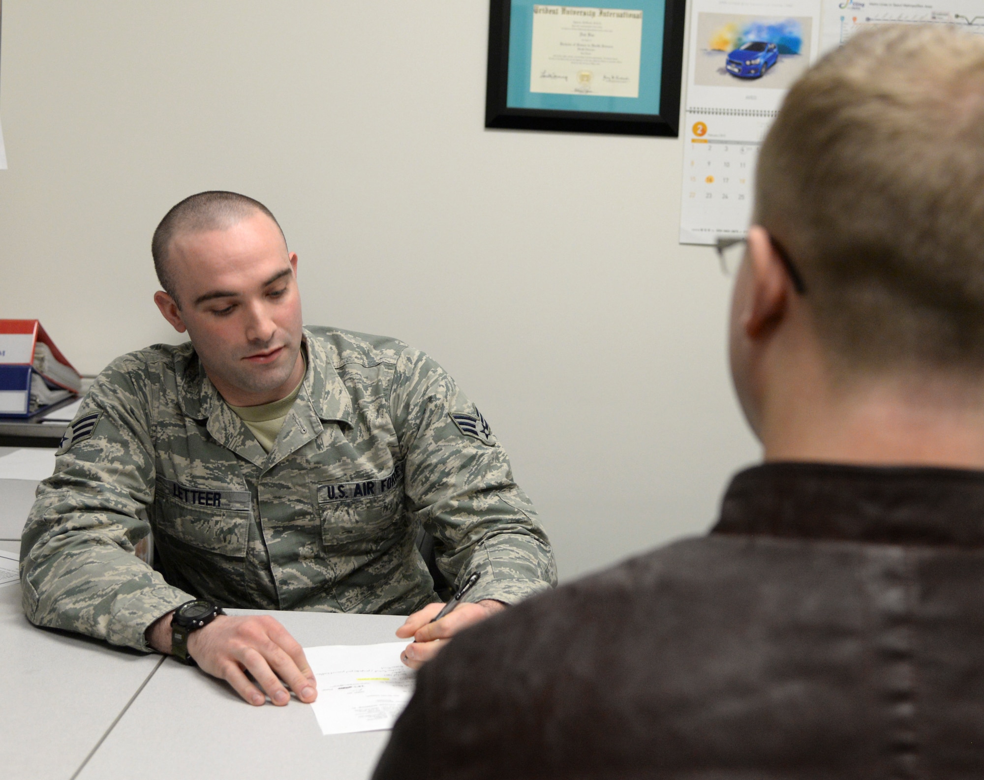 Senior Airman David Letteer, a 51st Aerospace Medicine Squadron diet therapy technician, educates a patient on proper nutrition Feb. 17, 2015, at Osan Air Base, Republic of Korea. Patients who need assitance with diabetes, hypertension, and weight management would be referred to nutritional medicine by their primary care manager. (U.S. Air Force photo by Senior Airman Matthew Lancaster)