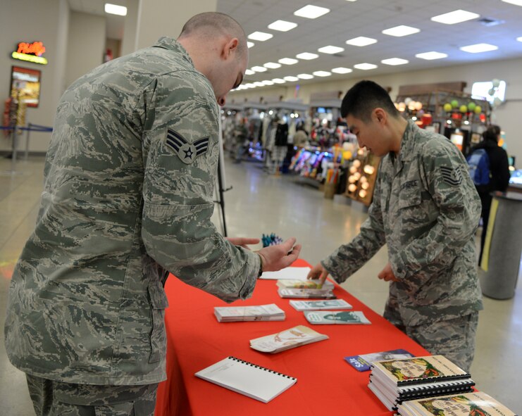 Senior Airman David Letteer, a 51st Aerospace Medicine Squadron diet therapy technician, and  Tech. Sgt. Duk Kim, 51st AMDS NCO in charge of nutritional medicine, set up a nutrition booth at the Base Exchange  Feb. 12, 2015, at Osan Air Base, Republic of Korea. In addition to the booth at the BX, nutrition medicine holds classes several times a month. (U.S. Air Force photo by Senior Airman Matthew Lancaster)