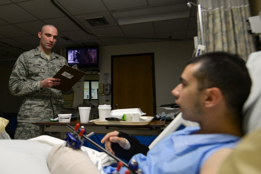 Senior Airman David Letteer, a 51st Aerospace Medicine Squadron diet therapy technician, does a nutrition screening with an inpatient Feb. 12, 2015, at Osan Air Base, Republic of Korea. This screen is done to ensure the patient recieves food that will best aid their recovery. (U.S. Air Force photo by Senior Airman Matthew Lancaster)