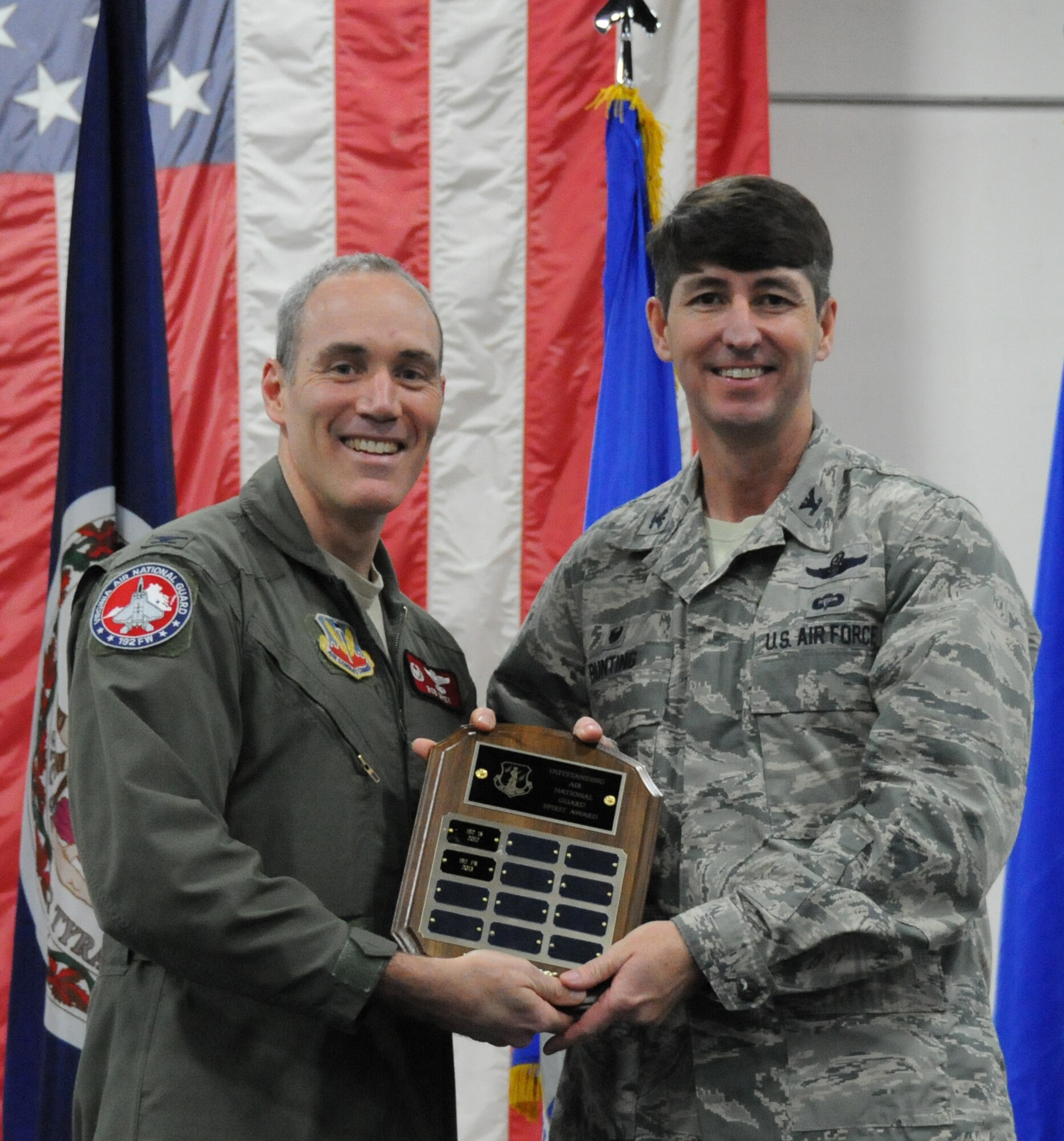 Col. Robert J. Grey, 192nd Fighter Wing commander, presents the “Outstanding Virginia Air Guard Spirit Award” to Col. Steve Bunting, 192d Maintenance Group commander, for the Maintenance Groups “Extreme Airfield Maintenance” themed table. The Maintenance Group table decorations took the award this year over all other tables during the awards banquet. (U.S. Air National Guard photo by Airman 1st Class Johnisa B. Roberts /Released)