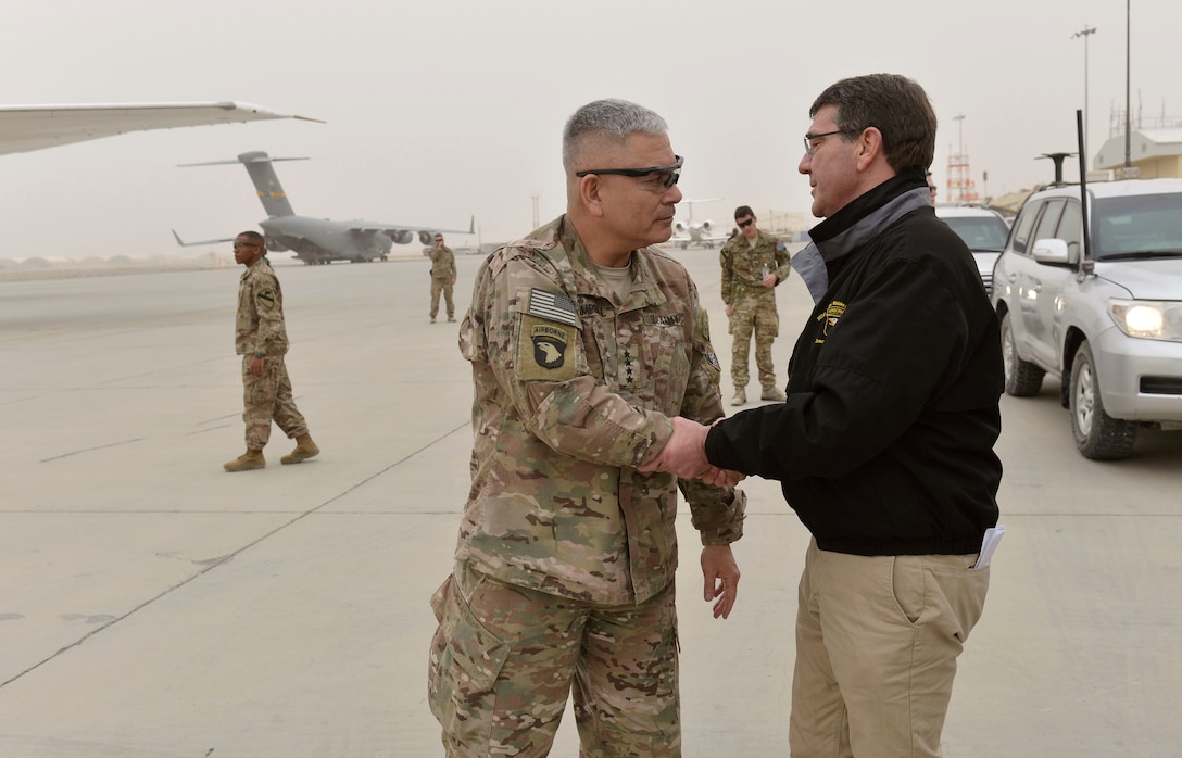 U.S. Defense Secretary Ash Carter shakes hands with U.S. Army Gen. John F. Campbell, commander of U.S. forces in Afghanistan and Operation Resolute Support, after visiting troops on Kandahar Airfield, Afghanistan Feb. 22, 2015. 