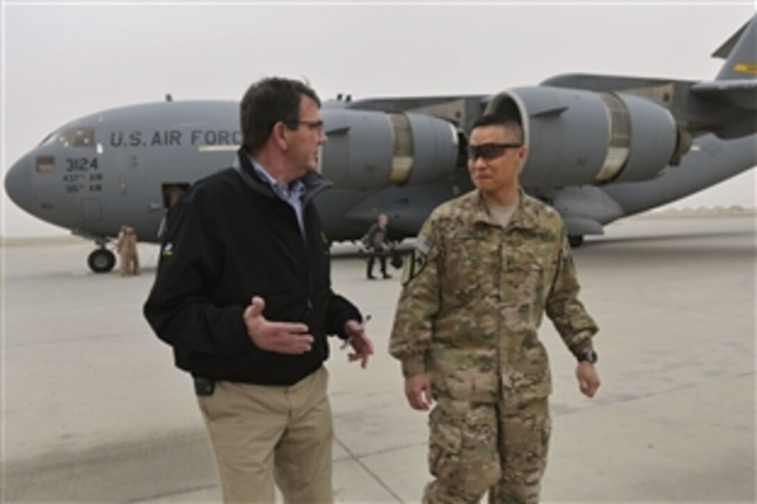 U.S. Defense Secretary Ash Carter talks with U.S. Army Brig. Gen. Viet Luong, commander of Train, Advise, Assist Command South, as he arrives on Kandahar Airfield, Afghanistan, Feb. 22, 2015. Carter received updates from leaders and met with service members during his first visit as secretary. 