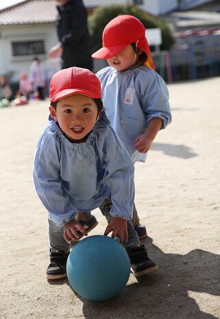 Midoro Hoikuen students play kickball with volunteers from the Marine Corps Air Station Iwakuni, Japan, during a community relations preschool event in Iwakuni City, Feb. 19, 2015. Coordinated by the Marine Memorial Chapel aboard station, volunteers spent the morning dancing, singing, learning and playing with the Japanese children. 