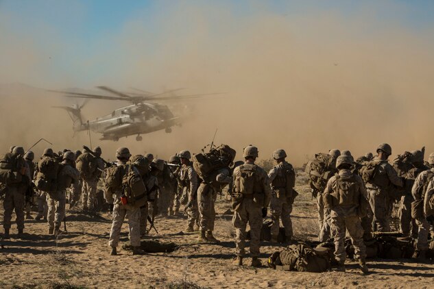 Marines prepare to board three CH-53E Super Stallions as part of an aerial assault for the Battalion Assault Course on Feb. 12 at Marine Air Ground Combat Center Twentynine Palms, California, during Integrated Training Exercise 2-15. The aerial assault is designed to suppress an enemy and provide other units security by controlling their flank before the other ground forces move through objectives. The Marines are with Company F, 2nd Battalion, 3rd Marine Regiment, 3rd Marine Division, III Marine Expeditionary Force. The CH-53E Super Stallions are with Marine Heavy Helicopter Squadron 462, 3rd Marine Aircraft Wing, I Marine Expeditionary Force.