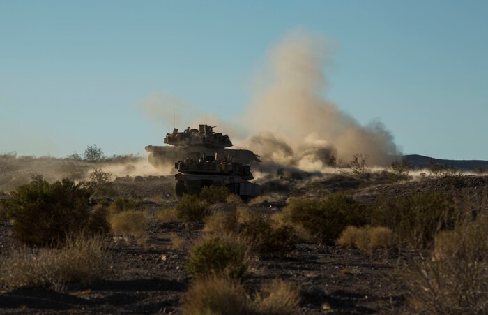 Marines fire at objectives to repel a simulated enemy assault Feb. 9 at Marine Air Ground Combat Center Twentynine Palms, California, during the battalion assault course at Integrated Training Exercise 2-15. M1A1 Abrams Main Battle Tanks fire a 120 mm cannon to provide direct and indirect fire to allow ground forces to assault an objective. The Marines operating the Abrams are with Company D, 1st Tank Battalion, 1st Marine Division, I Marine Expeditionary Force. 