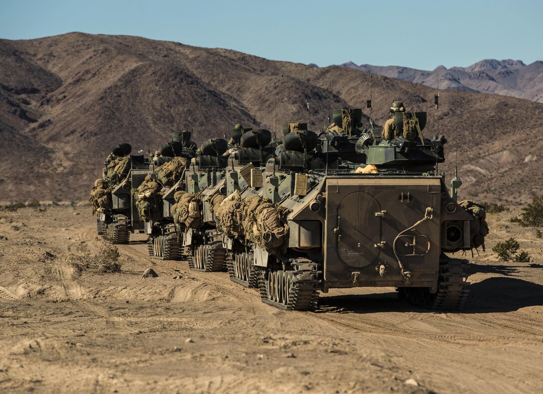 Infantry Marines move to counter-attack the enemy’s attack in the later stage of the battalion assault course Feb. 10 at Marine Air Ground Combat Center Twentynine Palms, California, during Integrated Training Exercise 2-15. Infantry Marines use amphibious assault vehicles to move across the battle space faster and safer than on foot. The infantry Marines are with 1st Battalion, 4th Marine Regiment, 1st Marine Division, I Marine Expeditionary Force. The AAV operators are with Company D, 3rd Amphibious Assault Battalion, 1st Marine Division, I Marine Expeditionary Force. 