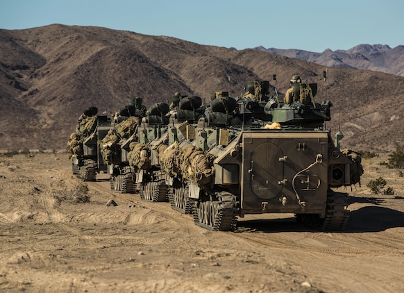 Infantry Marines move to counter-attack the enemy’s attack in the later stage of the battalion assault course Feb. 10 at Marine Air Ground Combat Center Twentynine Palms, California, during Integrated Training Exercise 2-15. Infantry Marines use amphibious assault vehicles to move across the battle space faster and safer than on foot. The infantry Marines are with 1st Battalion, 4th Marine Regiment, 1st Marine Division, I Marine Expeditionary Force. The AAV operators are with Company D, 3rd Amphibious Assault Battalion, 1st Marine Division, I Marine Expeditionary Force. 