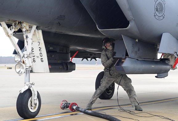 An Airman prepares an F-15E Strike Eagle for hot pit refueling Feb. 10, 2015, at Seymour Johnson Air Force Base, N.C. Hot pit refueling alleviates stress on an aircraft’s engines by reducing the number of times they are switched on and off. The Airmen is assigned to the 335th Aircraft Maintenance Unit and the F-15E is assigned to the 335th Fighter Squadron. (U.S. Air Force photo/Senior Airman Ashley J. Thum)