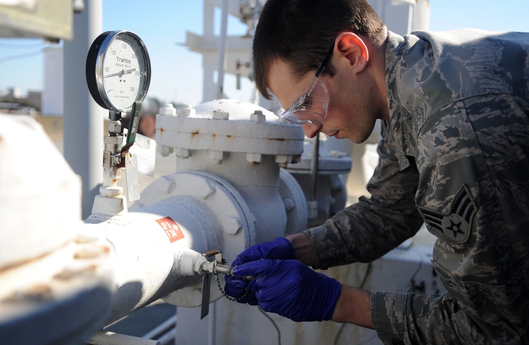 Senior Airman Noah Lazurka takes a sample from a fuel tank Feb. 11, 2015, at Seymour Johnson Air Force Base, N.C. Petroleum, oil and lubricants Airmen perform regular checks to ensure the quality of the base’s jet and ground fuel. Lazurka is a 4th Logistics Readiness Squadron fuels laboratory technician. (U.S. Air Force photo/Senior Airman Ashley J. Thum)