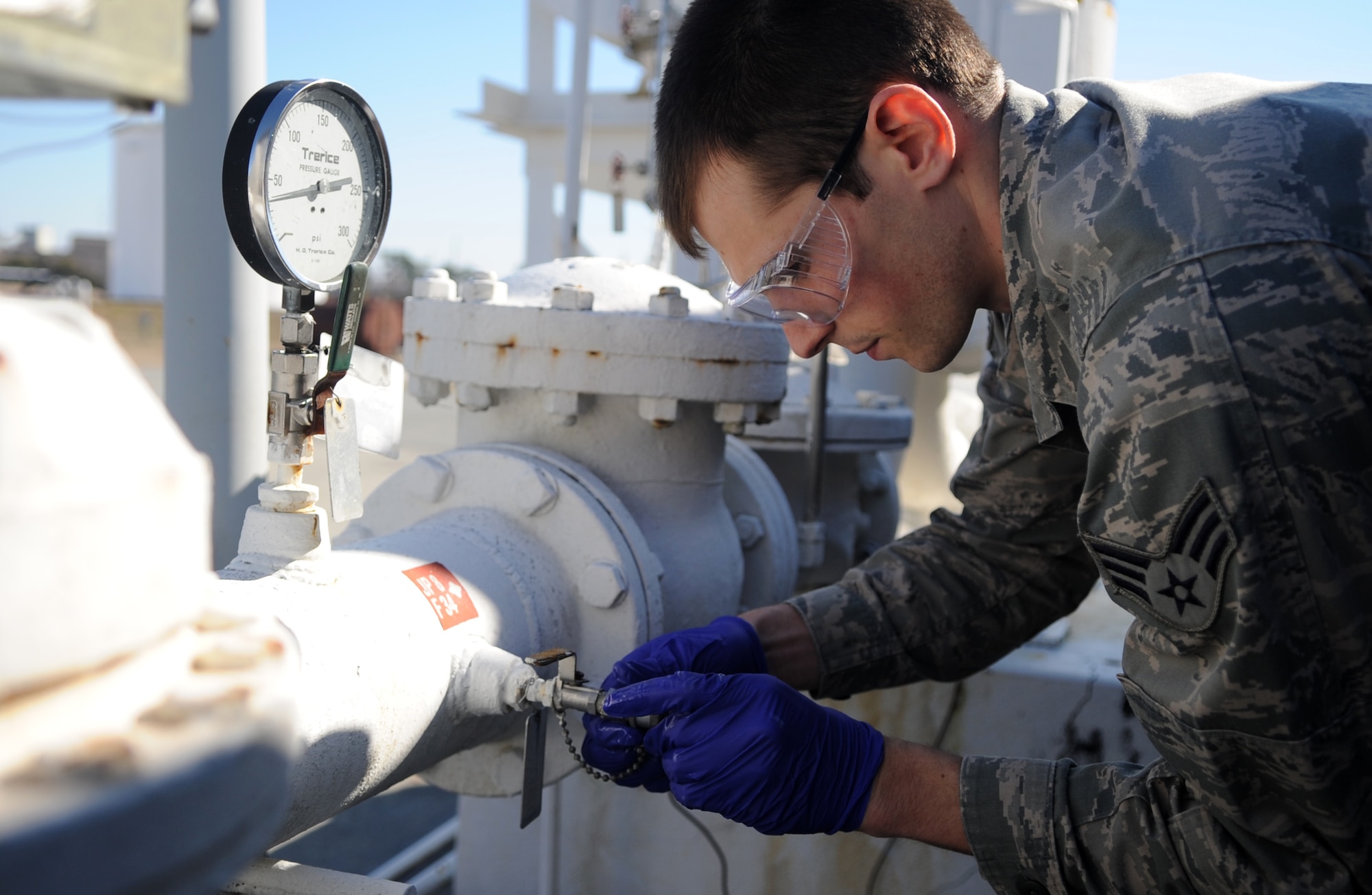 Senior Airman Noah Lazurka takes a sample from a fuel tank Feb. 11, 2015, at Seymour Johnson Air Force Base, N.C. Petroleum, oil and lubricants Airmen perform regular checks to ensure the quality of the base’s jet and ground fuel. Lazurka is a 4th Logistics Readiness Squadron fuels laboratory technician. (U.S. Air Force photo/Senior Airman Ashley J. Thum)