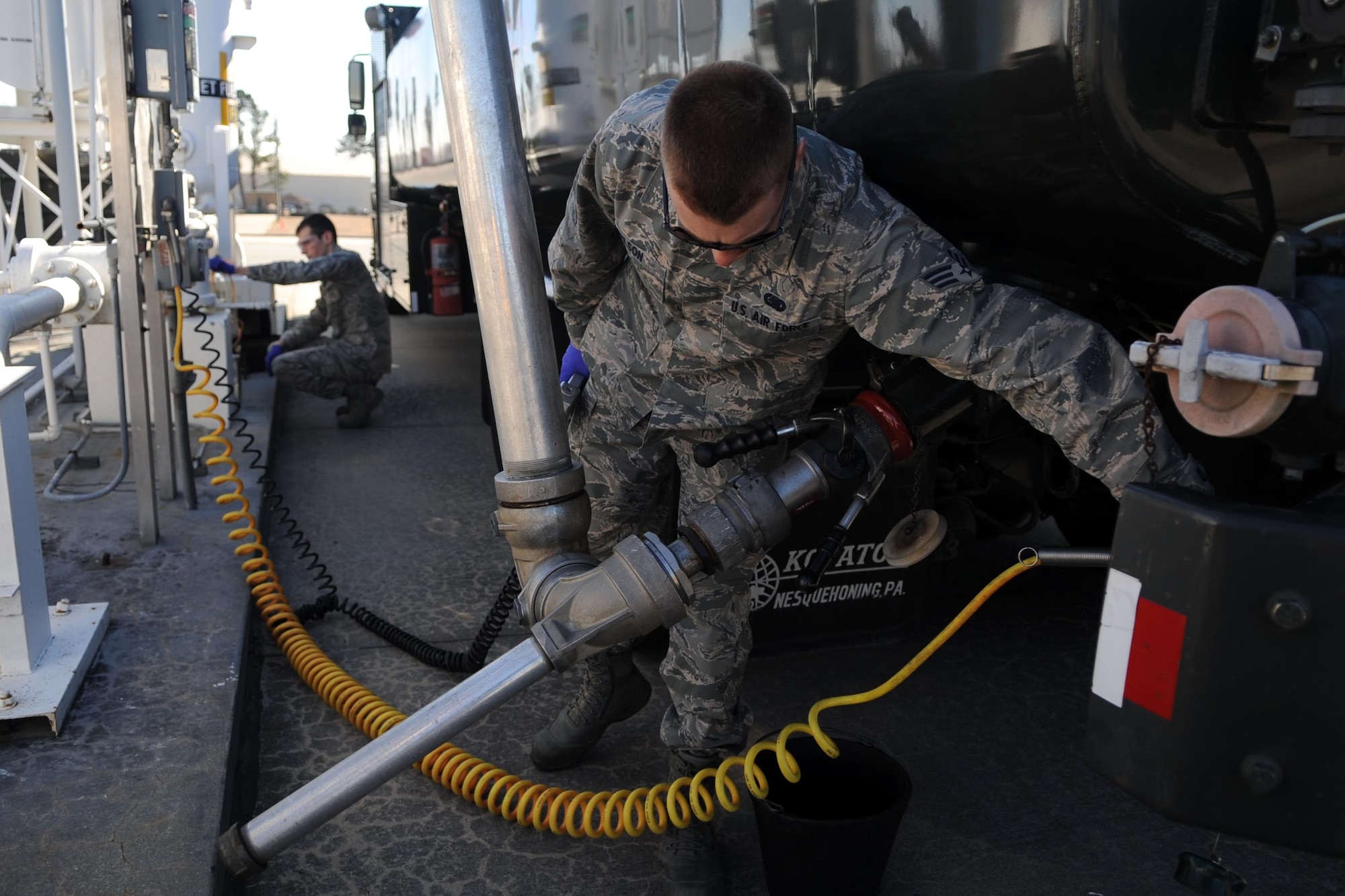 Senior Airmen Derek Wilson, foreground, and Noah Lazurka sample the fuel from a tank Feb. 11, 2015, at Seymour Johnson Air Force Base, N.C. Laboratory technicians test all fuel upon receipt, and at various other scheduled intervals. Wilson and Lazurka are both 4th Logistics Readiness Squadron fuels laboratory technicians. (U.S. Air Force photo/Senior Airman Ashley J. Thum)