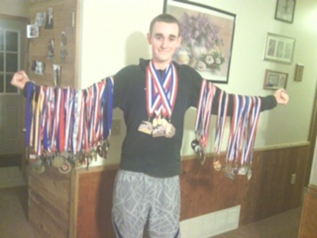 Lance Cpl. Bobby Sproule poses for a photo with his martial arts medals. Sproule is a marcher in Company A at Marine Barracks Washington, D.C. Sproule started martial arts at the age of six and continued until he was seventeen.  He trained in Tae Kwon Do, and maintains his second degree black belt. 