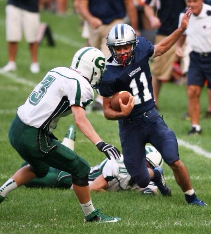 Lance Cpl. William C. Blunt breaks a tackle during a high school football game. Blunt a Company A marcher at Marine Barracks Washington, D.C, was a starting varsity athlete all four years in high school baseball and football from 2009 to 2013.