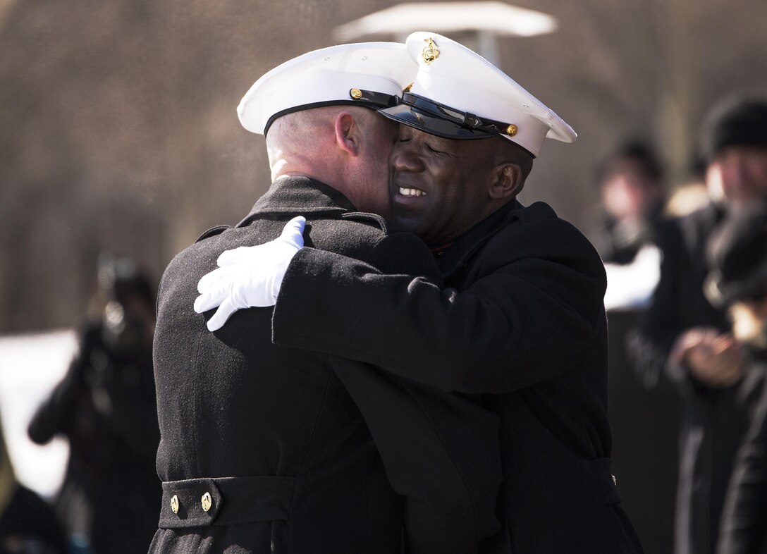 Sergeant Major Micheal P. Barrett congratulates Sergeant Major Ronald L. Green in becoming the 18th Sergeant Major of the Marine Corps at the Marine Corps War Memorial in Arlington, Virginia, Feb. 20, 2015. The post of Sergeant Major of the Marine Corps was established in 1957 as the senior enlisted advisor to the Commandant of the Marine Corps, the first such post in any of the branches of the United States Armed Forces. (U.S. Marine Corps photo by Sgt. Ally Beiswanger/Released)