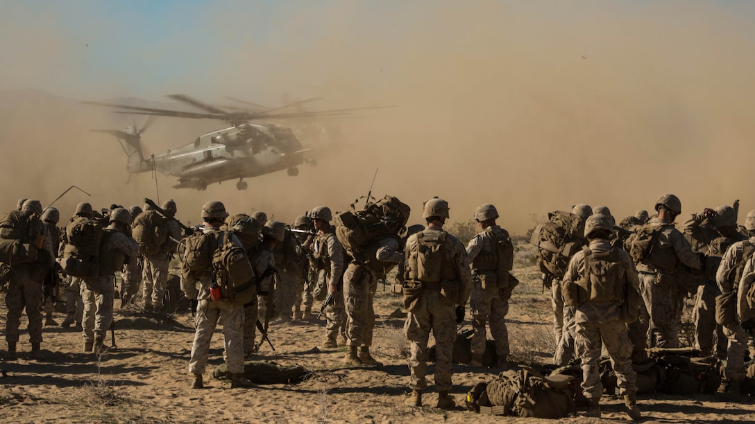 Marines prepare to board three CH-53E Super Stallions as part of an aerial assault for the Battalion Assault Course on Feb. 12 at Marine Air Ground Combat Center Twentynine Palms, California, during Integrated Training Exercise 2-15. The aerial assault is designed to suppress an enemy and provide other units security by controlling their flank before the other ground forces move through objectives. The Marines are with Company F, 2nd Battalion, 3rd Marine Regiment, 3rd Marine Division, III Marine Expeditionary Force. The CH-53E Super Stallions are with Marine Heavy Helicopter Squadron 462, 3rd Marine Aircraft Wing, I Marine Expeditionary Force. 