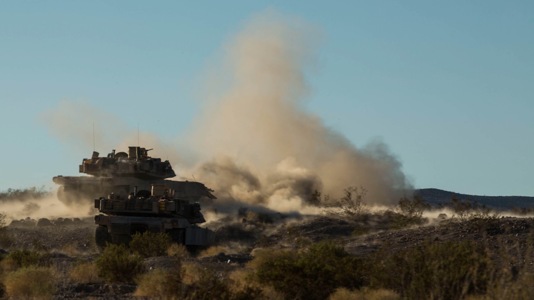 Marines fire at objectives to repel a simulated enemy assault Feb. 9 at Marine Air Ground Combat Center Twentynine Palms, California, during the battalion assault course at Integrated Training Exercise 2-15. M1A1 Abrams Main Battle Tanks fire a 120 mm cannon to provide direct and indirect fire to allow ground forces to assault an objective. The Marines operating the Abrams are with Company D, 1st Tank Battalion, 1st Marine Division, I Marine Expeditionary Force.