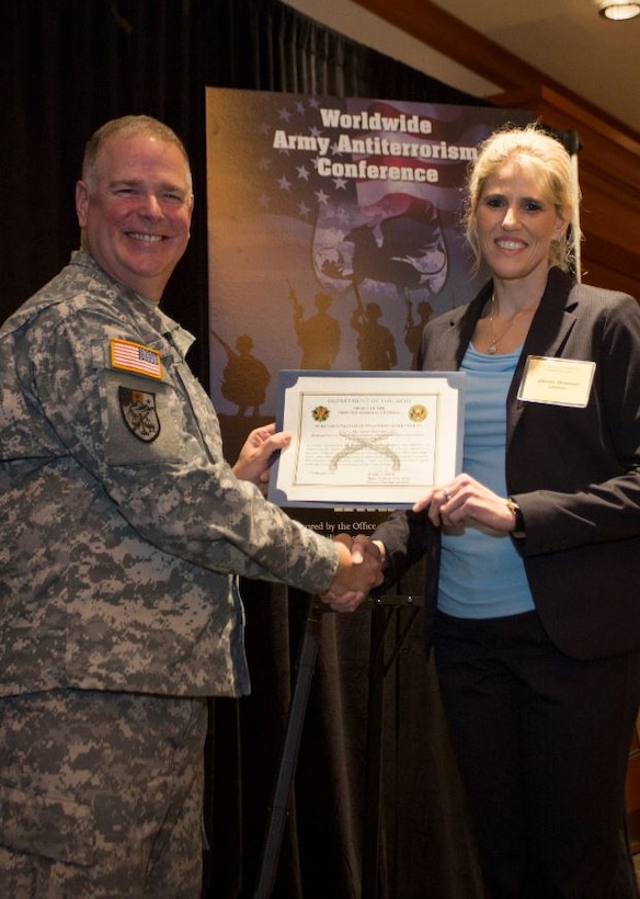 Jamie Grunner, (former) Resource Manager, Operational Protection Division, HQUSACE (right), receives AT Honor Roll Award from MG Mark Inch, Provost Marshal General (left) at the 2015 Annual Army Worldwide Antiterrorism Conference.
