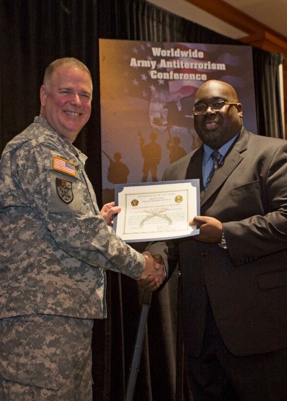 Jermaine March, Antiterrorism Officer, Philadelphia District (right), receives AT Honor Roll Award from MG Mark Inch, Provost Marshal General (left) at the 2015 Annual Army Worldwide Antiterrorism Conference.