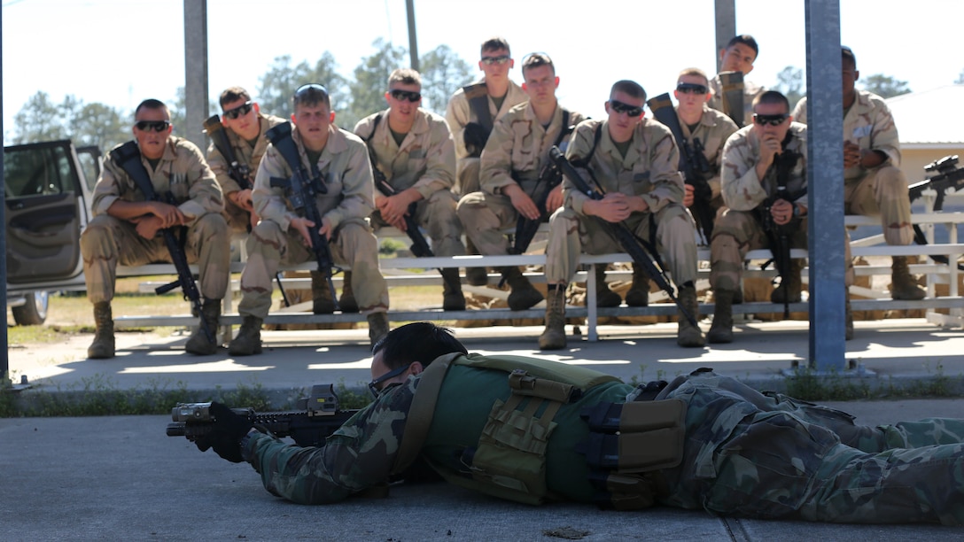 A Critical Skills Operator with 3rd Marine Special Operations Battalion, U.S. Marine Corps Forces Special Operations Command, teaches Marines with 2nd Combat Engineer Battalion, 2nd Marine Division, shooting techniques before firing M4 carbine rifles and M9 service pistols at a range here, Feb. 10, 2015. Marines with 3rd MSOB participated in RAVEN 15-03, a 10-day realistic military training exercise to enhance the battalion’s readiness for worldwide support to global security. Marines with 2nd CEB played the role of a partner nation force during the exercise.