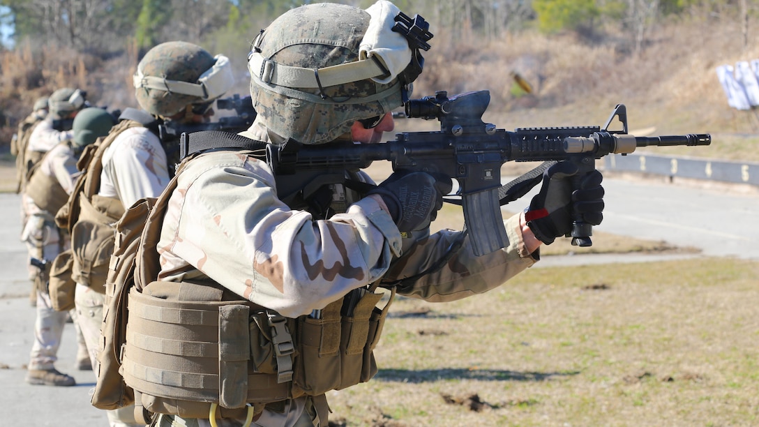 A Marine with 2nd Combat Engineer Battalion, 2nd Marine Division, fires an M4 carbine rifle at a range here, Feb. 10, 2015. Critical Skills Operators with 3rd Marine Special Operations Battalion, U.S. Marine Corps Forces Special Operations Command, trained with 2nd CEB Marines during RAVEN 15-03, a 10-day realistic military training exercise to enhance 3rd MSOB’s readiness for worldwide support to global security. Marines with 2nd CEB played the role of a partner nation force during the exercise. 