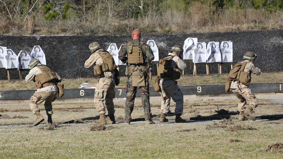 A Critical Skills Operator with 3rd Marine Special Operations Battalion, U.S. Marine Corps Forces Special Operations Command, watches as Marines with 2nd Combat Engineer Battalion, 2nd Marine Division, fire M4 carbine rifles at a range here, Feb. 10, 2015. Marines with 3rd MSOB participated in RAVEN 15-03, a 10-day realistic military training exercise to enhance the battalion’s readiness for worldwide support to global security. Marines with 2nd CEB played the role of a partner nation force during the exercise. 