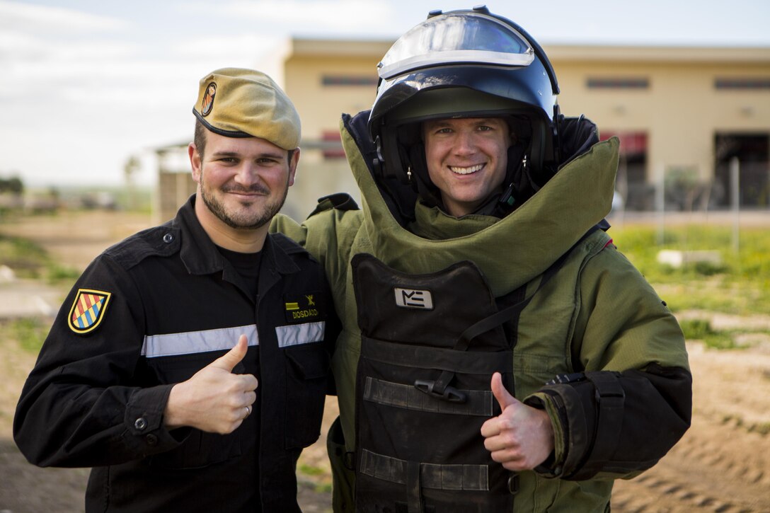 U.S. Marine Corps Capt. Christopher Bumgardner, right, a company commander with Special-Purpose Marine Air-Ground Task Force Crisis Response-Africa, and Spanish Defense Force Cabo Primero Antonio Diosadao, a noncommissioned officer with Unidad Militar de Emergencias, an emergency response unit, pose for a photo at Morón Air Base, Spain, Feb. 18, 2015. Bumgardner and Diosadao both tested out the suite during a joint training opportunity at the base.  (U.S. Marine Corps photograph by Sgt. Paul Peterson/Released)