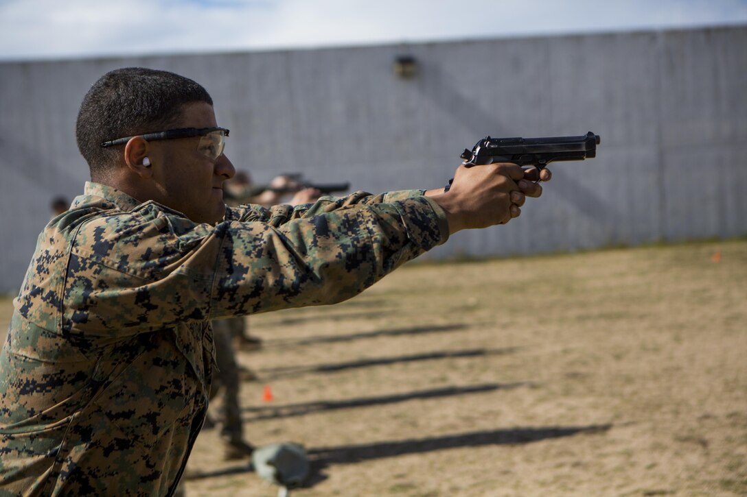 U.S. Marine Corps Cpl. Phillip Figueroa, a Marine with Special-Purpose Marine Air-Ground Task Force Crisis Response-Africa, fires an M9 pistol during a marksmanship qualification on Morón Air Base, Spain, Feb. 18, 2015. Marines and Sailors used the range as an opportunity to maintain their unit readiness and complete individual qualifications. (U.S. Marine Corps photograph by Lance Cpl. Christopher Mendoza/Released)