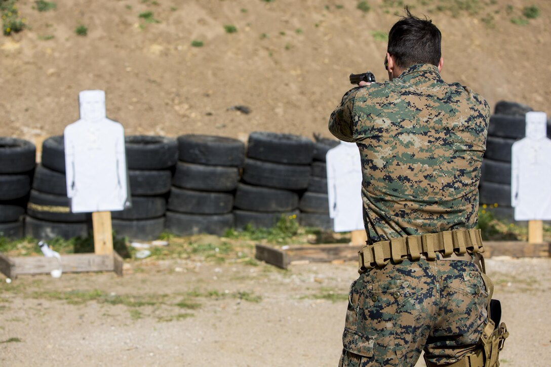 U.S. Navy Petty Officer 3rd Class Beau Champagne, a corpsman with Special-Purpose Marine Air-Ground Task Force Crisis Response-Africa, fires an M9 pistol on Morón Air Base, Spain, Feb. 18, 2015. Marines and Sailors maintained their shooting proficiency by organizing a range with the help of coaches already within the unit. (U.S. Marine Corps photograph by Lance Cpl. Christopher Mendoza/Released)