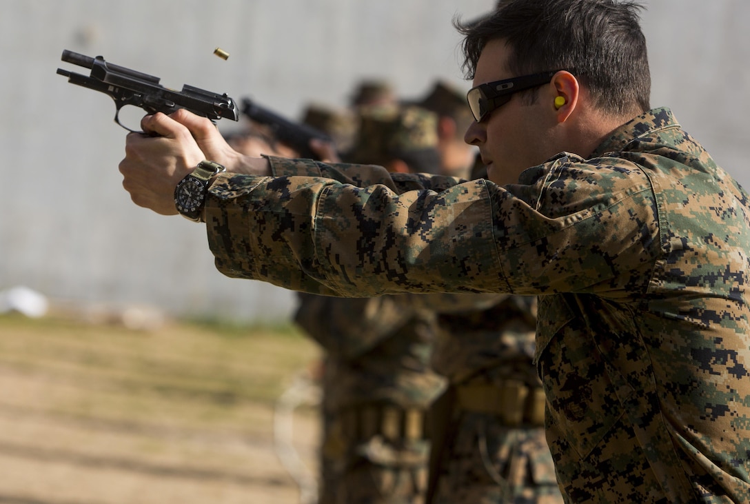 U.S. Navy Petty Officer 3rd Class Beau Champagne, a corpsman with Special-Purpose Marine Air-Ground Task Force Crisis Response-Africa, fires an M9 pistol on Morón Air Base, Spain, Feb. 18, 2015. The service members learned proper shooting techniques from experienced instructors within SPMAGTF-CR-AF. (U.S. Marine Corps photograph by Lance Cpl. Christopher Mendoza/Released)