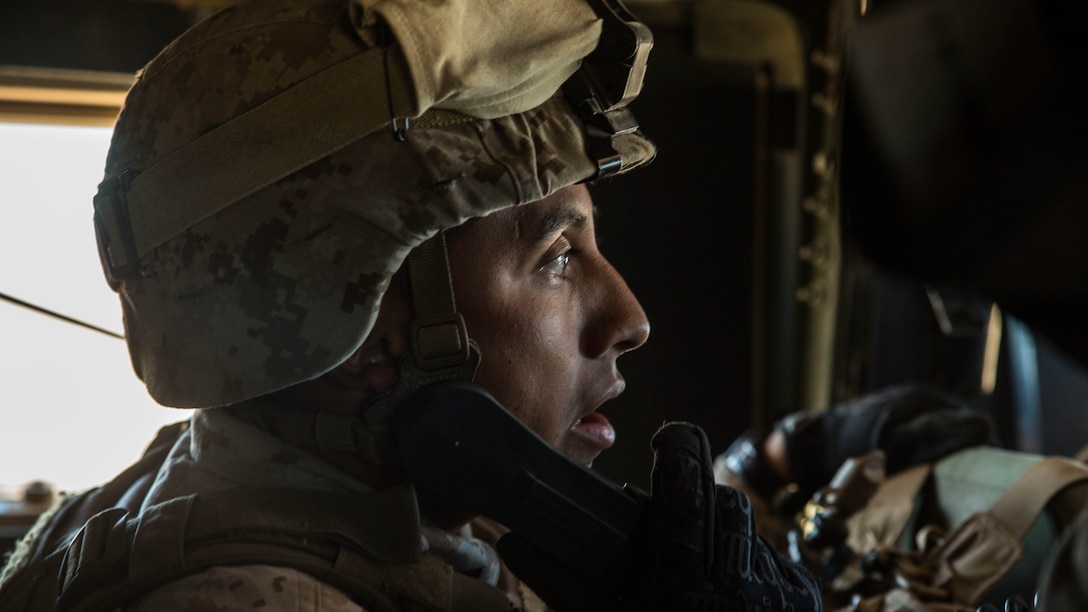 Staff Sgt. Absalon A. Cabrera uses a radio to communicate with the 4th Marine Regiment’s combat operations center while transporting the commanding officer across the battle space Feb. 12 at Marine Air Ground Combat Center Twentynine Palms, California, during the battalion assault course as part of Integrated Training Exercise 2-15. “I am very proud of all of my Marines,” said Cabrera. “They have accomplished a lot and it has been seen at different levels out here.” ITX 2-15 is designed to integrate combined arms and improve war fighting capabilities. Cabrera, a Los Angeles, California, native and an infantry unit leader, is the jump team commander for Special Purpose Marine Air-Ground Task Force Four with Headquarters Company, 4th Marine Regiment, 3rd Marine Division, III Marine Expeditionary Force. 