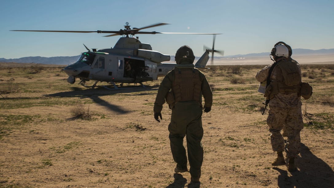Col. David L. Odom boards a UH-1Y Venom helicopter Feb. 12 at Marine Air Ground Combat Center Twentynine Palms, California, to command the fight from the sky during Integrated Training Exercise 2-15. Cpl. Christopher J. Benavidez flies with Odom to keep active communication with the combat operation center and the ground units during the battle. ITX 2-15 is designed to integrate combined arms and improve warfighting capabilities. Benavidez, a Livermore, California native, is a radio operator with Headquarters Company, 4th Marine Regiment, 3rd Marine Division, III Marine Expeditionary Force. Odom, a Hartsville, South Carolina, native, is the commanding officer for 4th Marines and Special Purpose Marine Air-Ground Task Force Four for ITX 2-15. 