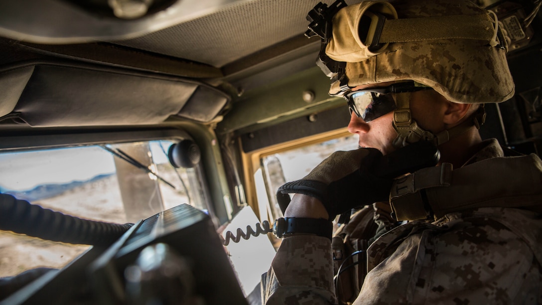 Lance Cpl. Bradley W. Walsh communicates with the rest of his convoy over the radio to maintain standard operating procedures Feb. 12 at Marine Air Ground Combat Center Twentynine Palms, California, during Integrated Training Exercise 2-15. During the battalion assault courses the jump team moved the command element’s commanding officer to a landing zone to be picked up by a UH-1Y Venom helicopter. The commanding officer was then able to command the fight from the sky. ITX 2-15 is designed to integrate combined arms and improve warfighting capabilities. Walsh, an rifleman, and Granville, Ohio, native, is the assistant convoy commander for the jump team with Headquarters Company, 4th Marine Regiment, 3rd Marine Division, III Marine Expeditionary Force. 