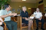 Brig. Gen. Mario Perezcassar, Nicaraguan chief of civil defense, relates information about his home country to Lt. Gov. Barbara Lawton, as Brig. Gen. Scott Legwold, Wisconsin National Guard chief of joint staff, looks on during a visit to the state capitol building May 26, 2010. The visit was part of a May 25-28 trip by Nicaraguan military officials to share emergency response information with Wisconsin Emergency Management and the Wisconsin National Guard.