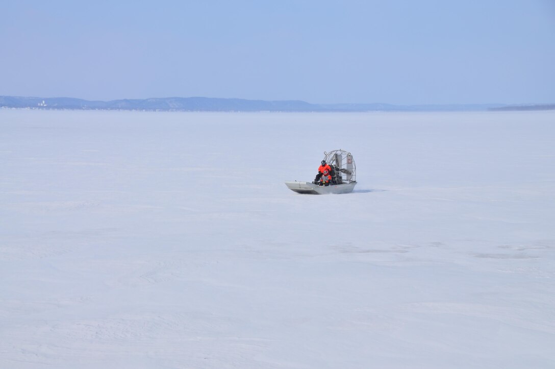 Airboat operator Bill Chelmowski and survey technician Kurt Schroeder scoot across frozen Lake Pepin as ice thickness measurements are taken on Feb. 18, 2015. St. Paul District staff from the channels and harbors section took to the ice of Lake Pepin on Feb. 18, for the first of weekly ice thickness measurements. The thickest ice discovered this year was at river miles 771 and 766, where 21 inches were recorded. 