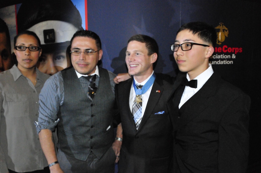 Medal of Honor recipient William Kyle Carpenter, center, who was the Guest of Honor at Friday night’s Marjah Marines Reunion Dinner at the National Museum of the Marine Corps, poses for a picture with Gunnery Sgt. Matt Mata, left, and his 13-year-old son, Erin. Matt Mata served in Marjah as a staff sergeant with the 1st Battalion, 6th Marine Regiment.