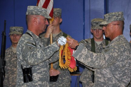 Indiana Army National Guard Col. David C. Wood, left, and Command Sgt. Maj. John A. Watson, the commander and top enlisted Soldier for the 38th Combat Aviation Brigade, encase the unit's colors during a transfer of authority ceremonyat Joint Base Balad Iraq, June 7, 2010. During the brigade's 10-month deployment, the unit conducted full-spectrum aviation operations including rotary- and fixed-wing direct and general support aviation missions in support of United States Forces-Iraq.